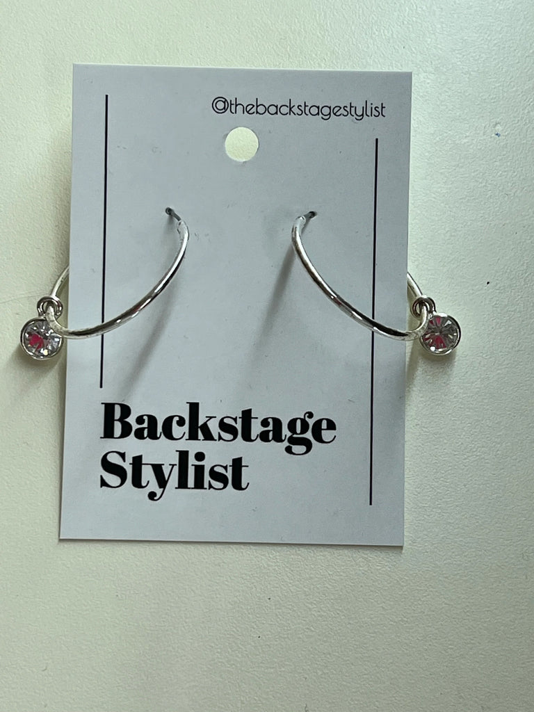Silver metal hoop earrings with crystal charm